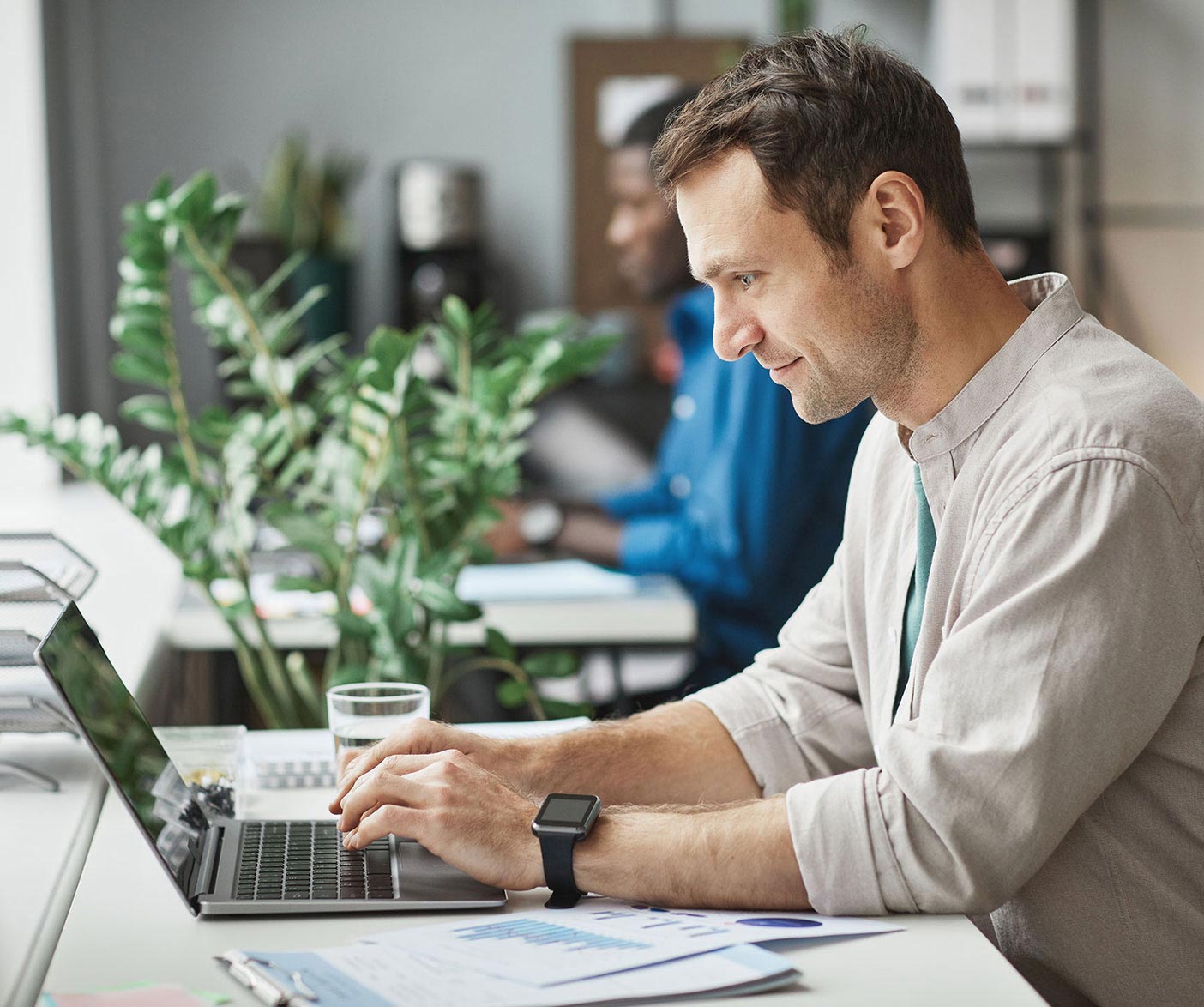 A young man works on his laptop.