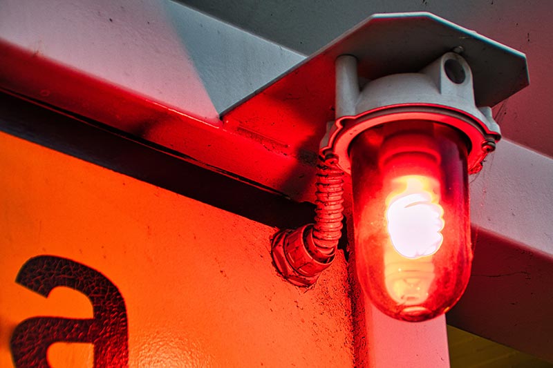 A red alert light flashes.