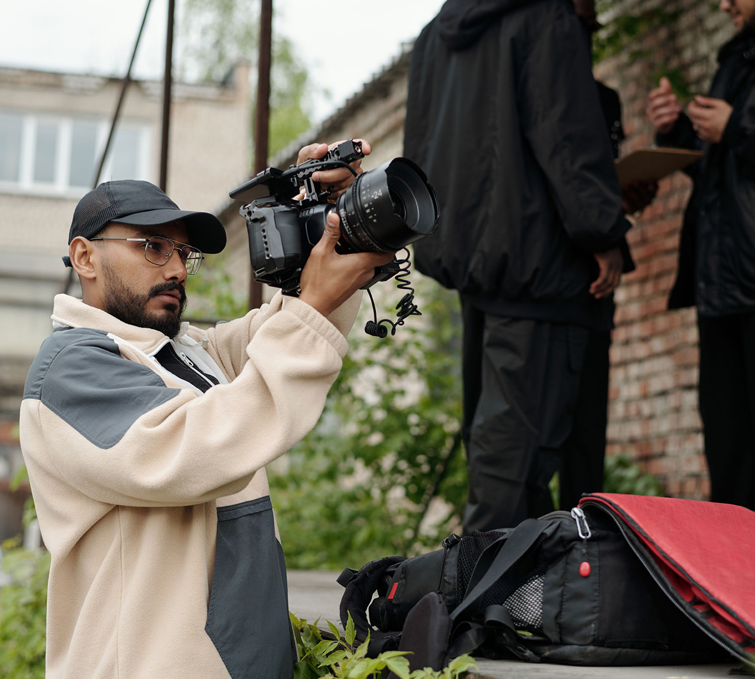 A young man sets up a video shot with a camera.