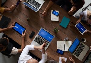 A group of people work around a table.