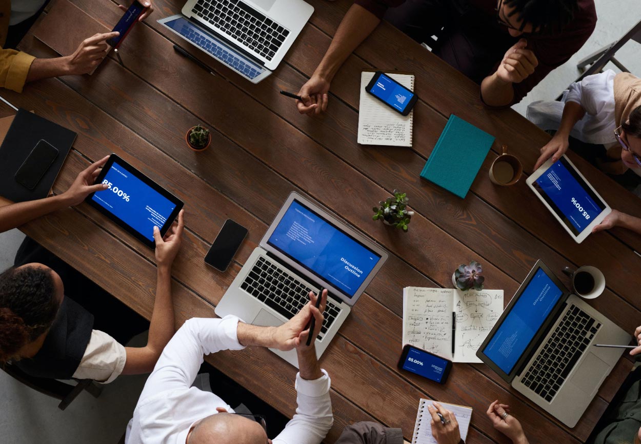 A group of people work around a table.